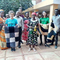 A pose picture of students together with their local host community and project products