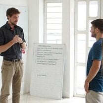 man teaching another man