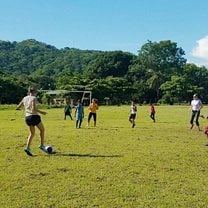 We go to play football against a local team on the most beautiful football field.