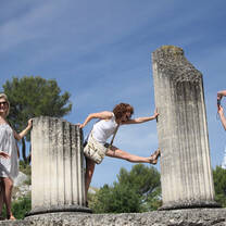 Students pose playfully with ancient columns.