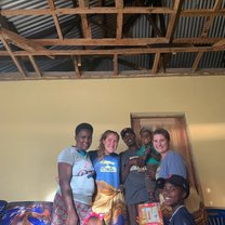 A photo of my homestay partner and I with our homestay family.