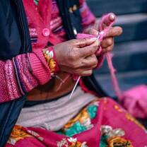 person knitting in peru