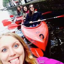 Students kayak in Amsterdam's canals