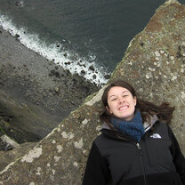 A student lays by a cliff