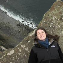 A student lays by a cliff