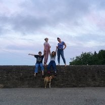 4 students standing on the wall at Cowhouse