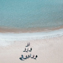 people making triangle on the beach 