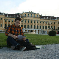 A student reads on the lawn