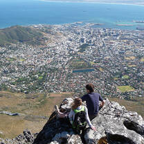 A student on a mountaintop overlooking Cape Town