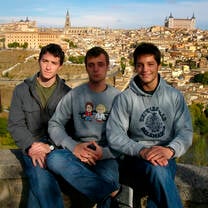 Students pose in front of the city