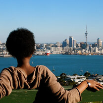 A student visiting Mount Victoria in Devonport, Auckland, looking at Auckland CBD's skyline