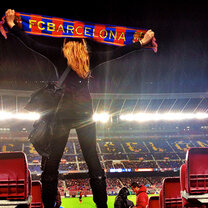 A student cheering on Barcelona at a football game