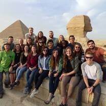 Students pose in front of the Sphinx and Great Pyramids in Egypt