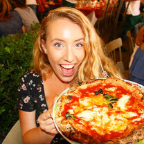A student poses excitedly with her pizza!