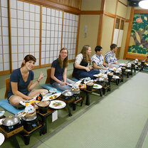 Students eating a traditional Japanese dinner