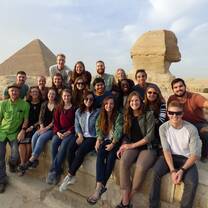 Students pose in front of the Sphinx and Great Pyramids in Egypt