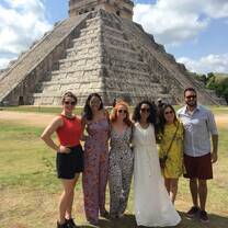 international friends standing in front of a pyramid 