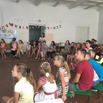 30 youth sitting in a gymnasium watching a slideshow