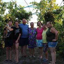 Photo of host family (including cat) and two volunteers (mom and daughter).