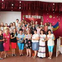 The entire group in the gymnasium on the final day, holding Ukrainian flags