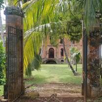 Looking through a broken gate into the primary courtyard and prison ruins on Ile Royale, largest of the Salvation's Islands, infamous French prison from 1852 to 1953.