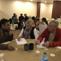 Volunteers discussing a project with a local official