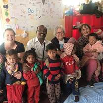 Volunteers in a classroom with small Nepalese children