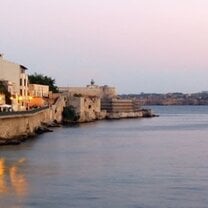 ocean and city landscape with sunset 