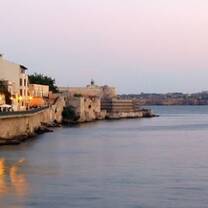 ocean and city landscape with sunset 