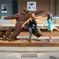 students posing in front of street art statue 