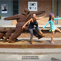 students posing in front of street art statue 