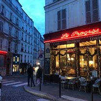 A parisienne street we wandered to, red neon lights light up a store front.  