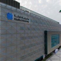 Khalifa University main campus building. A large and imposing structure that is surrounded by low rises and green spaces Khalifa University main campus building. A large and imposing structure that is surrounded by low rises and green spaces