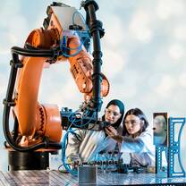 Two female students from Khalifa University work in the development facility.