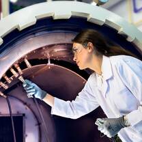 An international female student works on high technology in a laboratory setting.