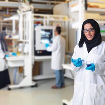A lab tech at Khalifa University poses in front of the expensive equipment she is proud to work with  A lab tech at Khalifa University poses in front of the expensive equipment she is proud to work with