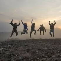 group of five people jumping for joy in Mexico