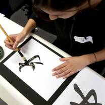 student learning Chinese calligrahy