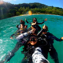 Conservation volunteers in Fiji in the water before a survey dive off the coast of Pacific Harbour
