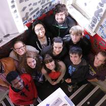 group of people standing in stairwell smiling