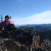 girl on mountaintop overlooking view of mountains in Montana