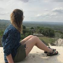 Girl overlooking Mayan ruins.