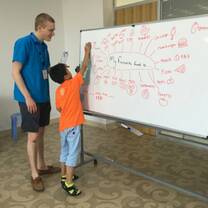 Photo of Volunteer and Child in a Classroom