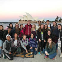 Students striking a pose in front of the famous Sydney Opera House.