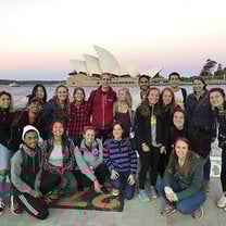Students striking a pose in front of the famous Sydney Opera House.