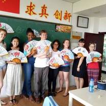 Cultural activities include traditional Chinese fan painting!