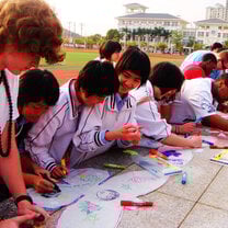 high school teens from language program taking activities: co-drawing and flying kites