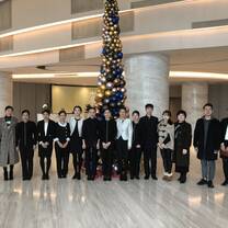 Law interns taking a group photo with co-workers in the hall