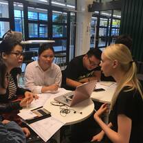 Interns from internship in china program having a project discussion with co-workers