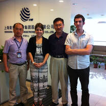 Interns from internship in china program having a group photo with co-workers at the office